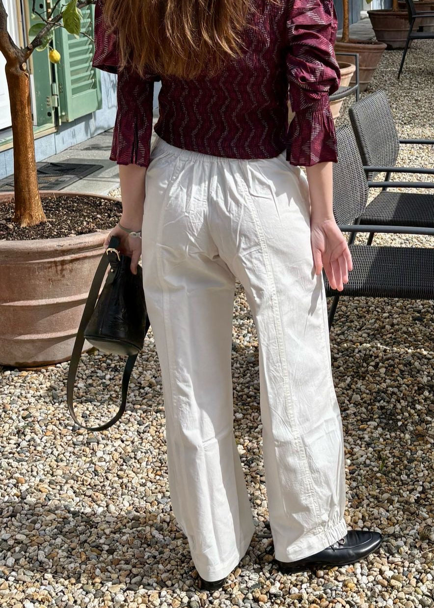 Balloon Pants in cotone denim bianco di Igi Ama sono realizzati al 100% in cotone, garantiscono una vestibilità regolare e si adattano facilmente a diverse corporature grazie all'elastico posteriore. Dotati di due tasche frontali, questi pantaloni uniscono funzionalità e design minimalista. La modella, alta 170 cm, indossa la taglia unica, pensata per offrire il massimo comfort. Prodotto in India, questo capo riflette la qualità dei materiali e l’attenzione ai dettagli.