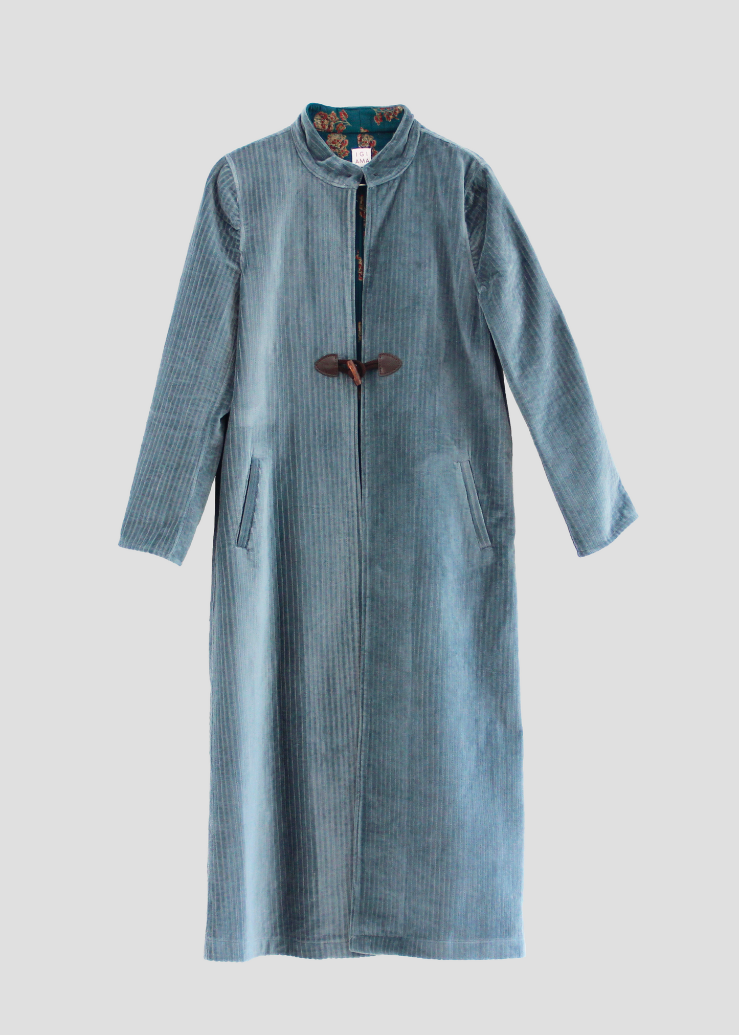 Alamari Coat in Light sky blue/wood Alamari, velvet light blue coat with wood alamari, mandarin collar, and frog buttons. Structured shoulders and polyester lining. Made in India with an elegant and refined design. Dry clean only, iron on low heat, do not bleach.