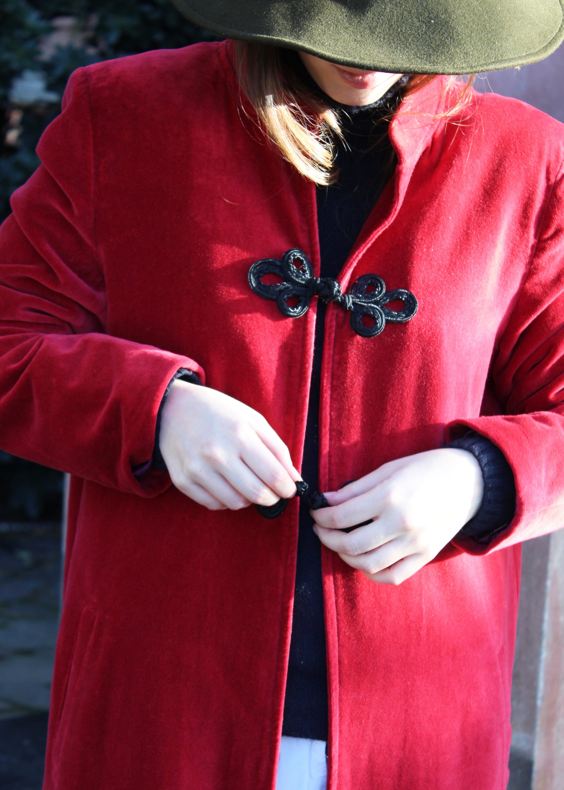 Alamari Coat in Red/Black Alamari, velvet red coat with black alamari, mandarin collar, and frog buttons. Structured shoulders and polyester lining. Made in India with an elegant and refined design. Dry clean only, iron on low heat, do not bleach.