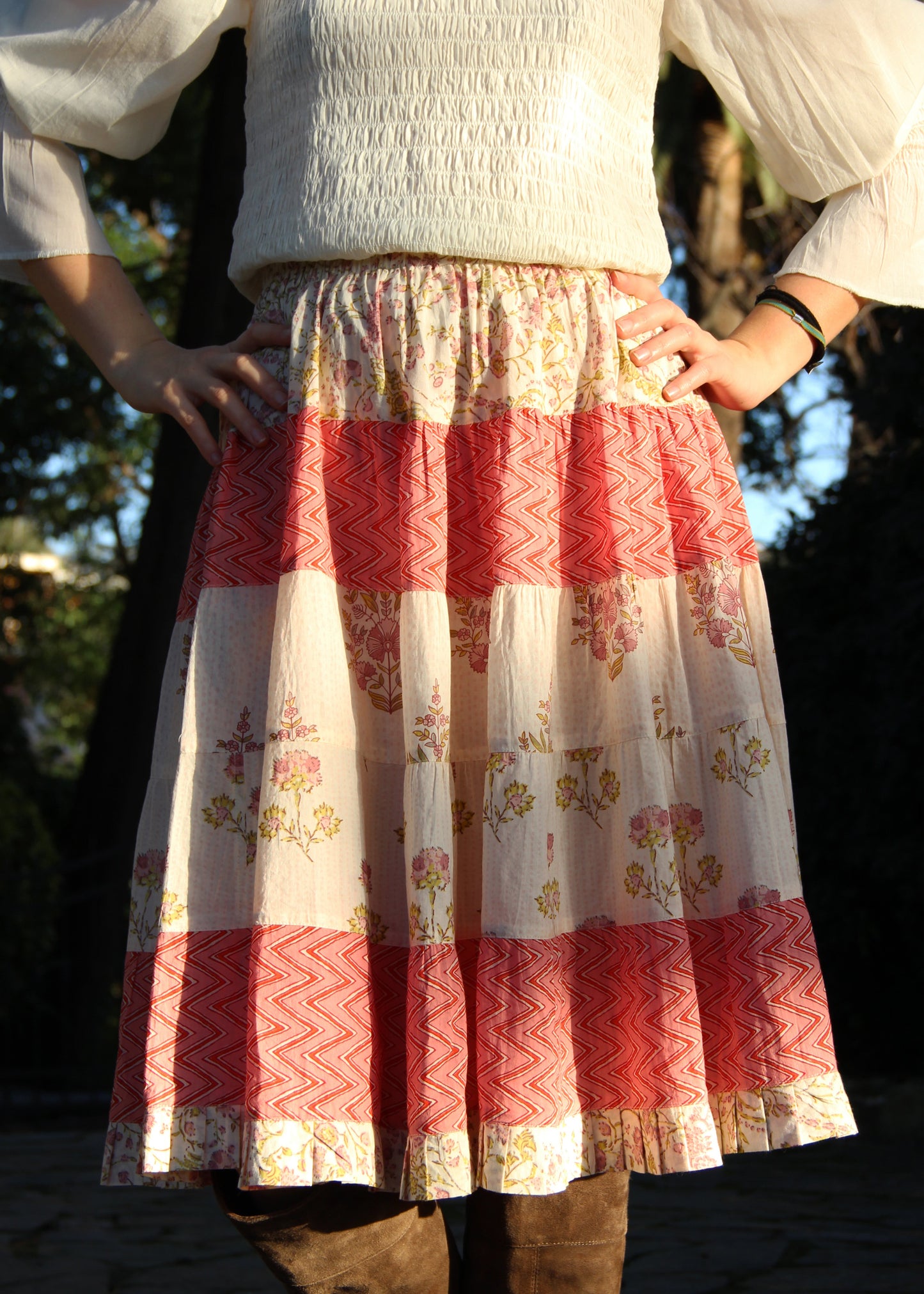 Hidi Midi Skirt in Pink, pink striped skirt with floral and zig zag pattern. Made from 100% patterned cotton, the Hidi Midi Skirt is elastic and fits all body types. Block printed pattern. Machine washable at 30°C, iron at low heat, made in India.