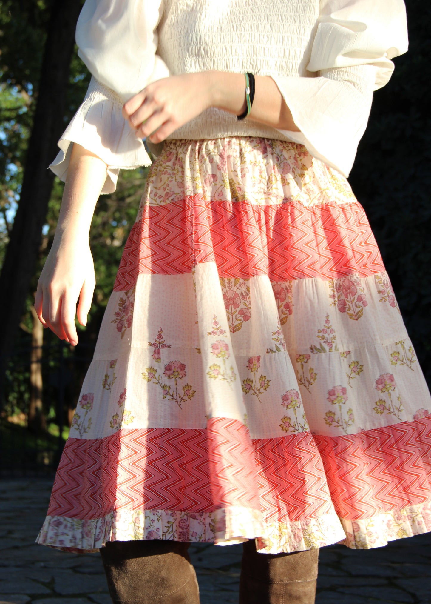 Hidi Midi Skirt in Pink, pink striped skirt with floral and zig zag pattern. Made from 100% patterned cotton, the Hidi Midi Skirt is elastic and fits all body types. Block printed pattern. Machine washable at 30°C, iron at low heat, made in India.